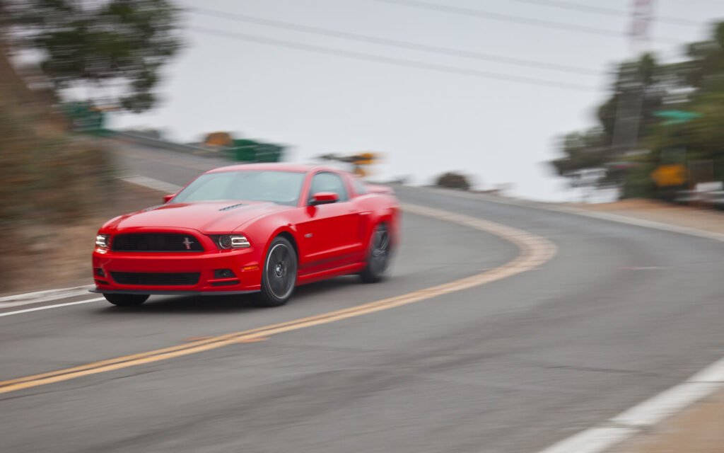 red car braking downhill