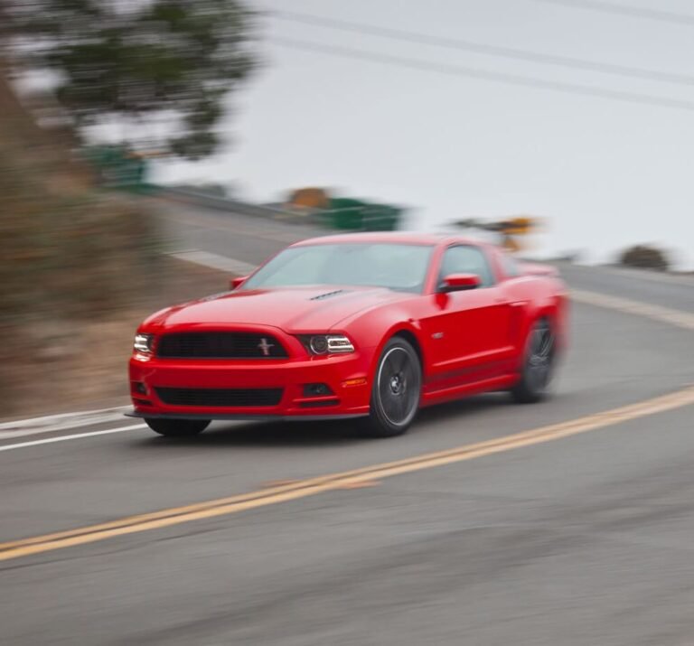 red car braking downhill